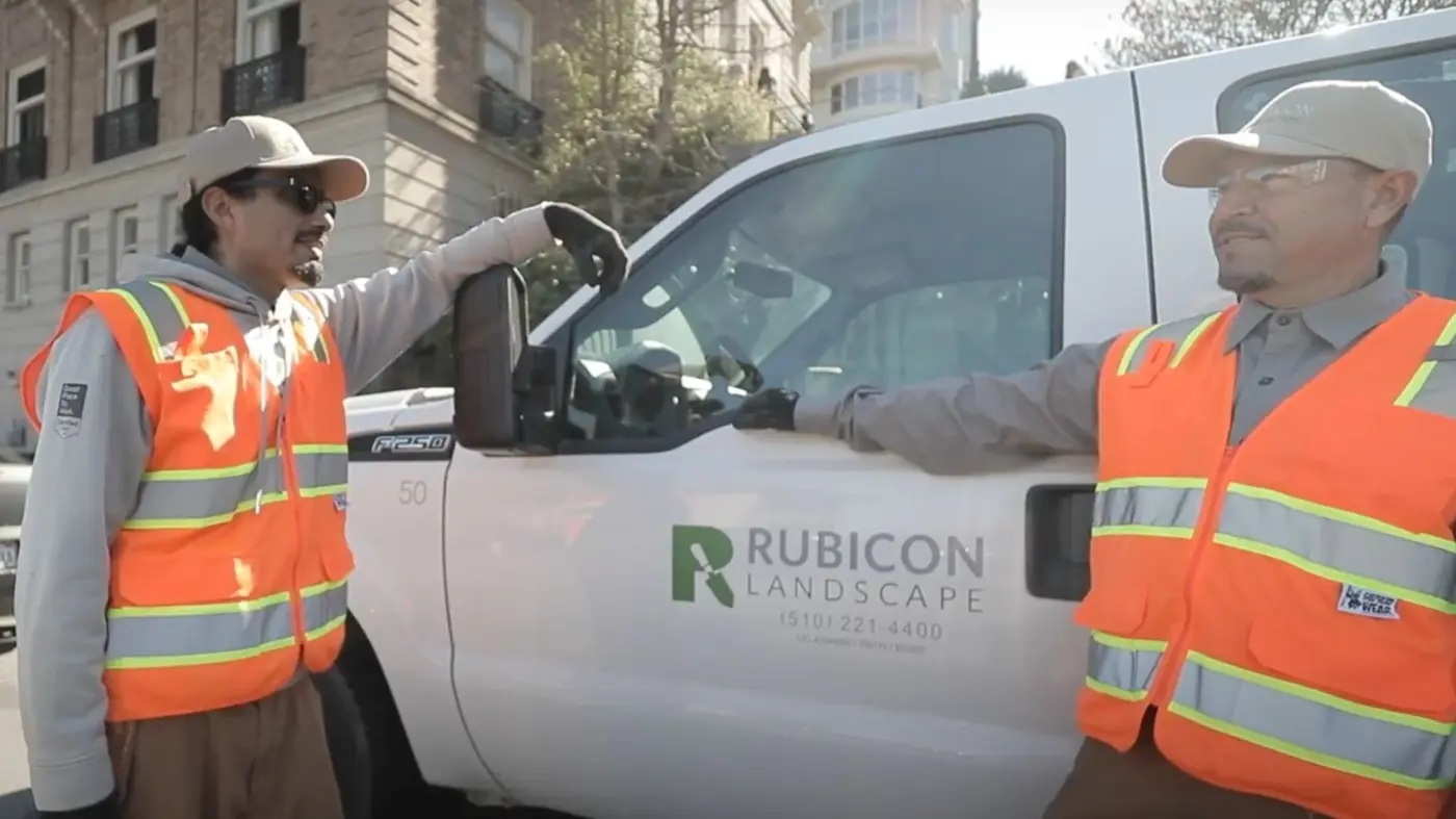 Rubicon crew members in safety vests beside a Rubicon Landscape service truck