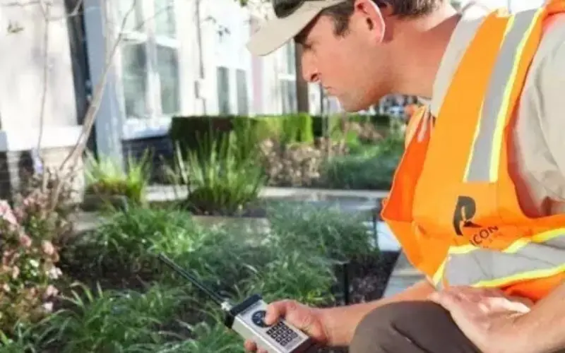 Rubicon technician checking a planted bed with a handheld device