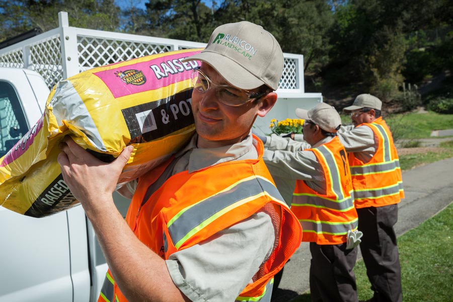 Rubicon crew members unloading planting supplies from a work truck