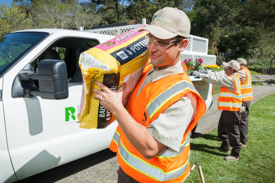 Rubicon crew members unloading planting supplies from a work truck