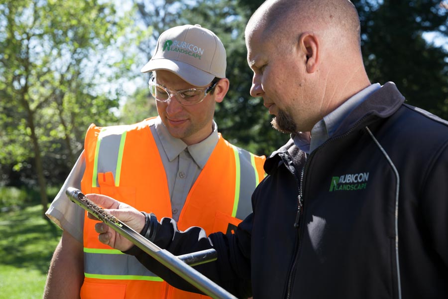 Rubicon supervisor reviewing a site plan with a crew member
