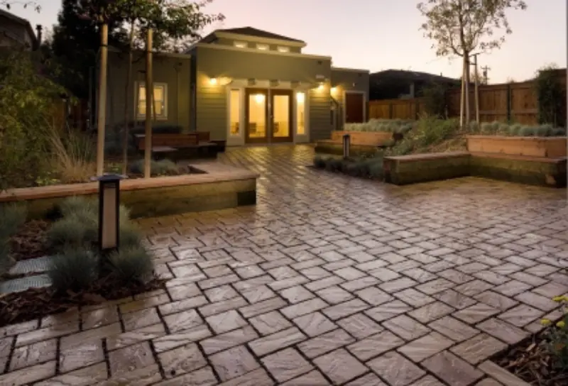 Paver courtyard and raised planters at Harmon Gardens in Berkeley at dusk